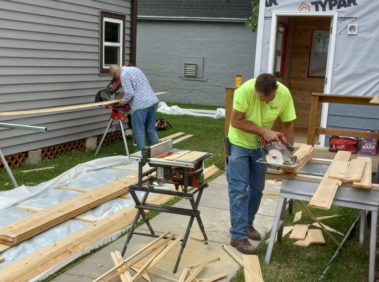 volunteers employees building new furnishings for tiny house Veterans Outreach of Wisconsin