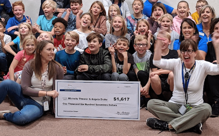 Canyons education foundation big check presented to teacher classroom of kids for innovation idea