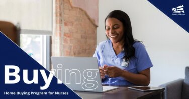 Woman nurse sitting at a computer smiling