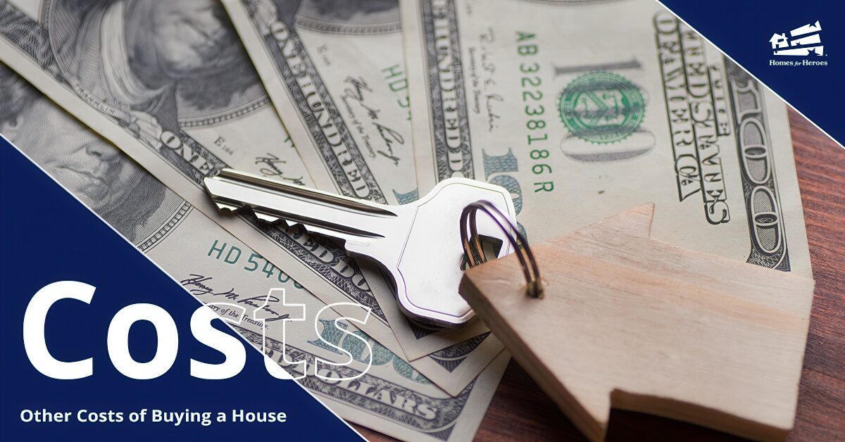 A pile of $100 bills fanned out with a keychain in the shape of a house with a single silver key laying on top of the money.