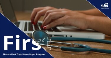 Woman typing on a laptop with a stethoscope next to it