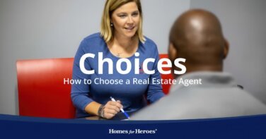 Homes for Heroes real estate agent meeting with home buyer who is wondering how to choose and buy home in office at desk