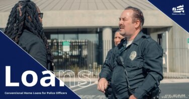 Male police officer and female partner behind him talk to male in a parking lot