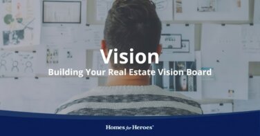 agent standing in front of board full of ideas to use for real estate vision board Homes for Heroes