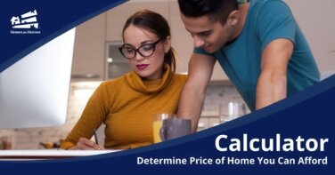 man standing behind woman sitting at table writing in front of cumputer using home affordability calculator to determine how much house can i afford