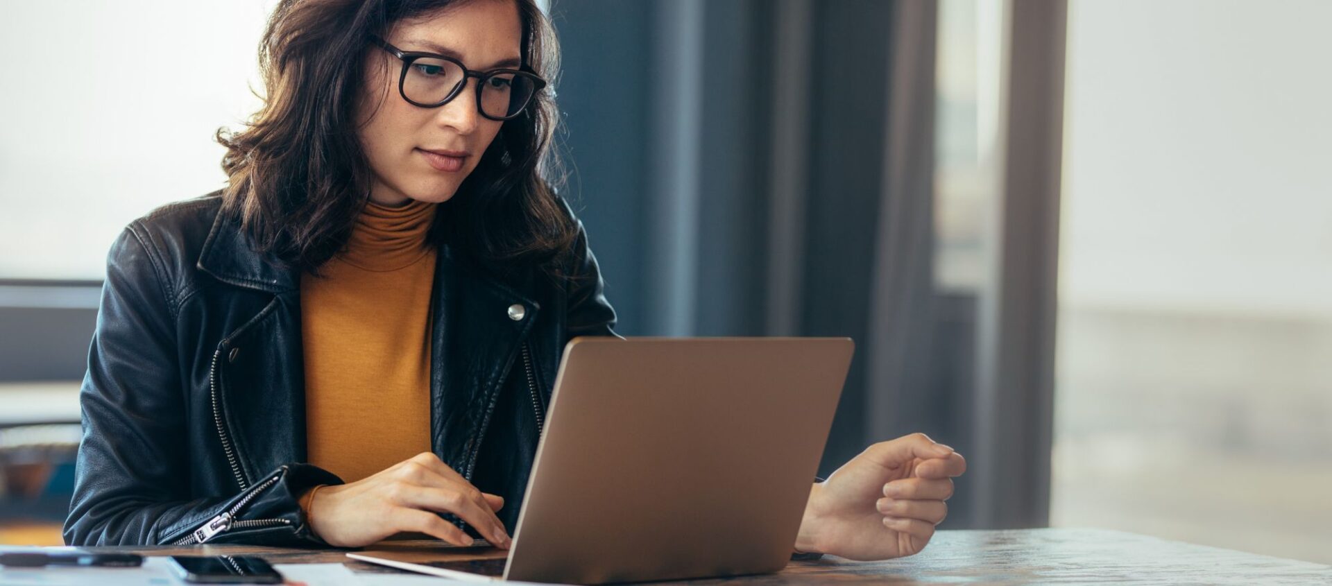 woman real estate agent sitting at desk working on laptop learning how to do lead gen in less time with artificial intelligence ai grey transparent overlay