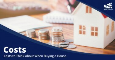 home model stacked coins pad of paper on deck to determine the cost to buy a house Homes for Heroes