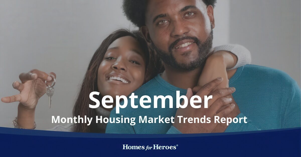 man woman holding new house key smiling after closing on new home and watching housing market trends for months Homes for Heroes