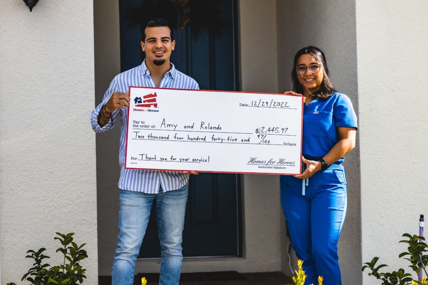 Amy and Rolando celebrate closing with Homes for Heroes big check