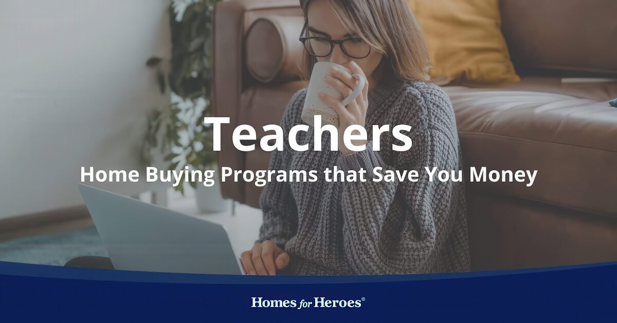 woman sitting on floor next to couch sipping tea on laptop reading about teacher home buying programs Homes for Heroes