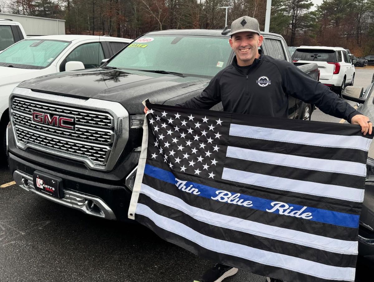 JD Thin Blue Ride founder holding law enforcement blue line flag