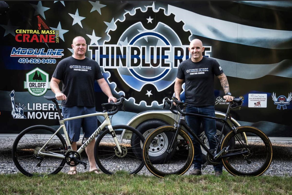 Thin Blue Ride biking event co-founders holding bikes in front of trailer