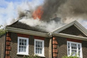 Brick home with roof on fire