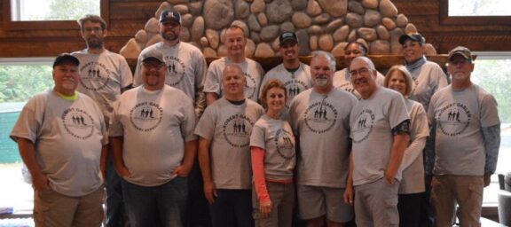 Healing Patriots group wearing Robert Gabler honorary expedition tee shirts in lodge